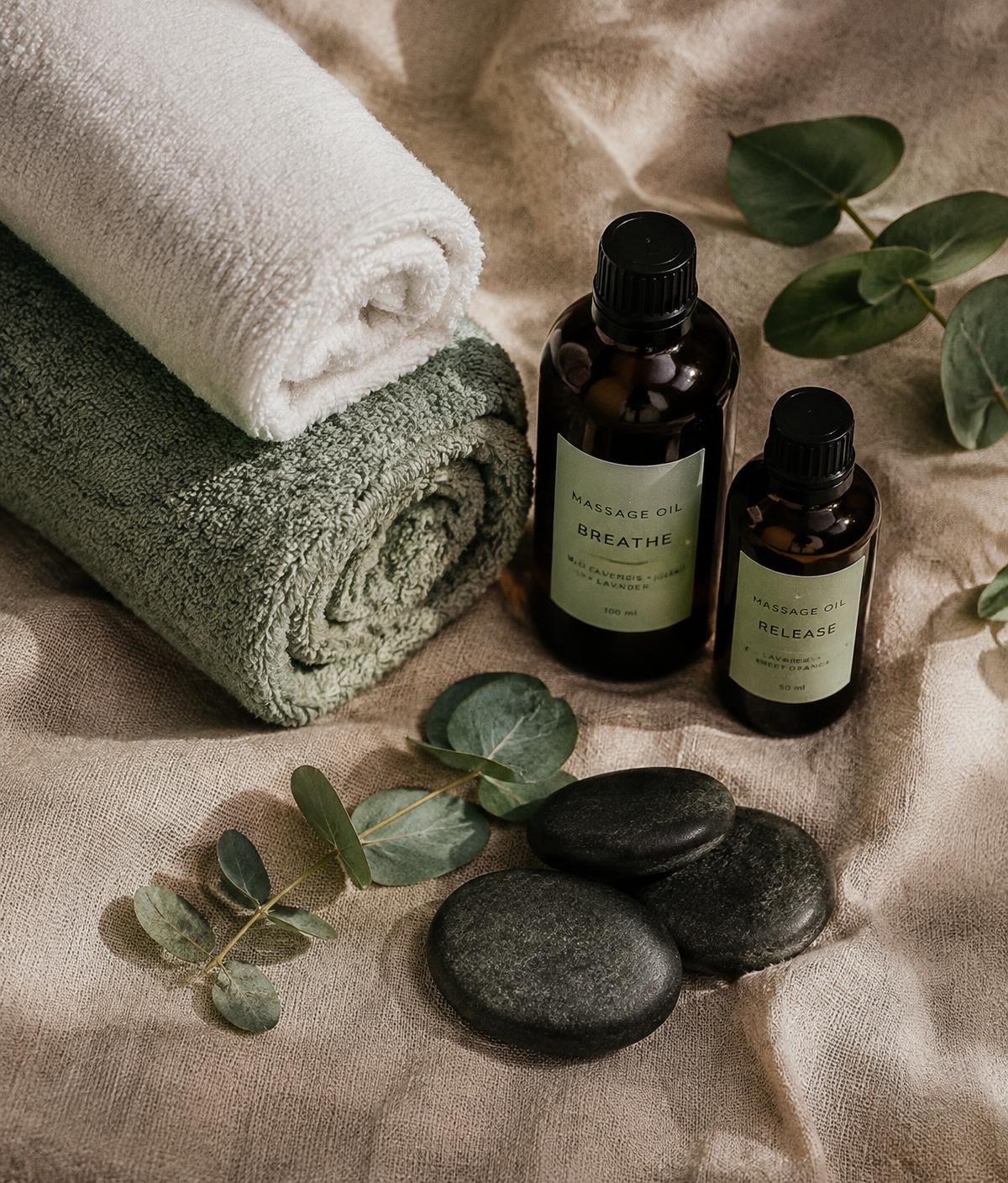 Rolled towels, massage oils, eucalyptus and stones